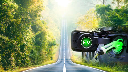 Charge EV electric car hybrid technology. Drive clean energy on nature travel with icon illustration EV electronic vehicle blur background future green eco car environment friendly power conceptの写真素材