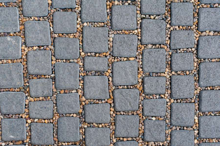 Cobble Stone Pavement Background, Old Stone floor , square stones and small round stones in between