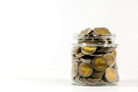 Glass jars with coins on white backgroundの写真素材