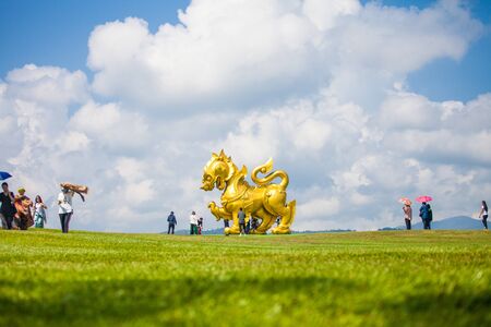 CHIANG RAI, THAILAND - October 26, 2019 : Tourists are taking photos with a large golden Singha (Lion) statue at Singha Park (Boon Rawd Farm), Chiang Rai province, Thailandのeditorial素材