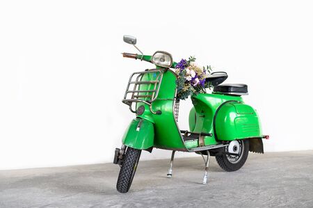 Bangkok,Thailand - June 22 : Green vintage Vespa Italian designed scooter is parking in building...