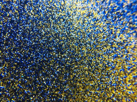 Abstract glittering texture with golden and blue sparksの写真素材