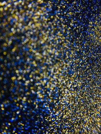 Abstract glittering texture with golden and blue sparksの写真素材