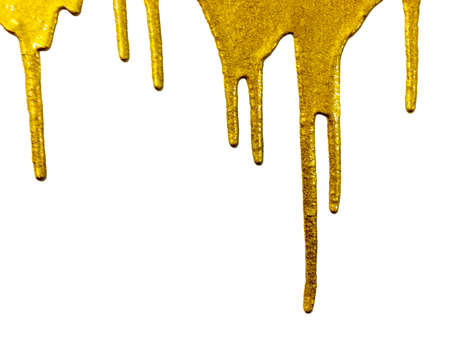 gold paint dripping on backgroundの写真素材