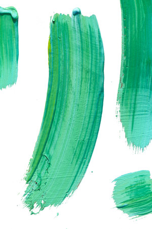 green paint brush strokes isolated on white background, abstract acrylic painting on paperの写真素材