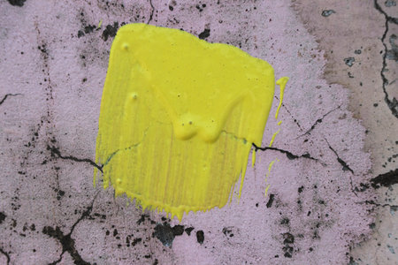 yellow paint on the old wall, abstract background, closeup of photoの写真素材