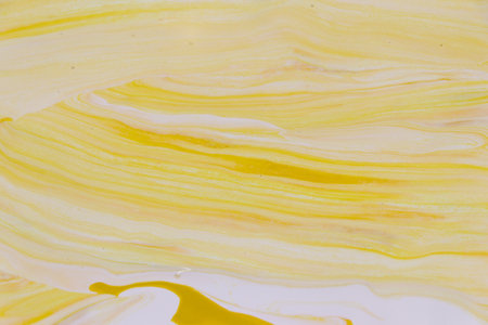 abstract background of acrylic paint in yellow and white colors, macro photographyの写真素材