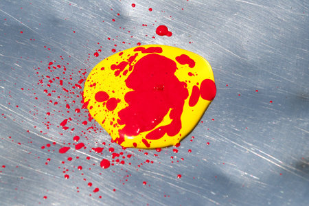 Colorful splatter on a metal surface. Abstract background.の写真素材