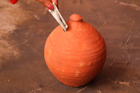 Hand of potter working in pottery workshop, closeup of photoの写真素材