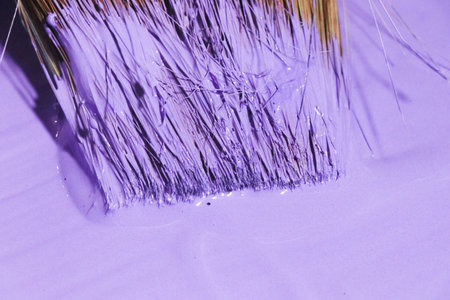 Paint brushes on a purple background, close-up of photo