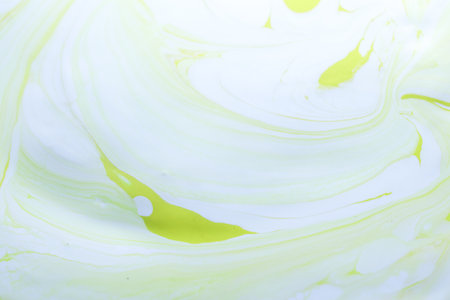 abstract background of yellow and green paint on a white background.