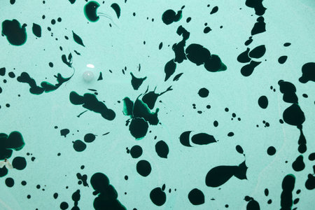 Abstract watercolor background. Green and black spots on a blue background.