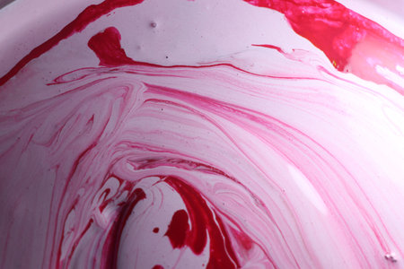 Abstract background of pink and red paint mixing in a glass bowl.の写真素材