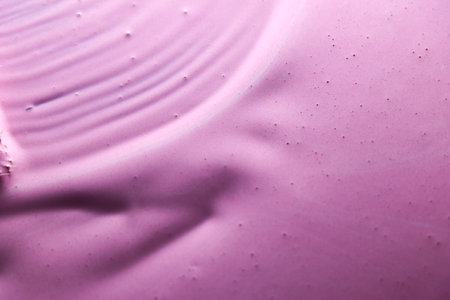 abstract background of pink acrylic paint on water surface close-upの写真素材