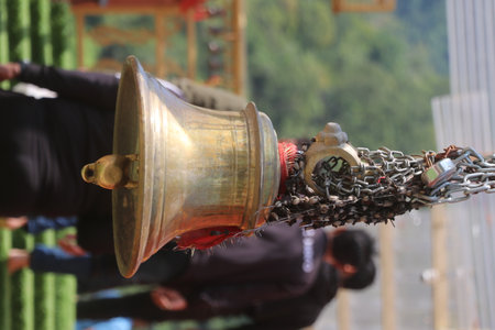 Buddhist temple bell with chain, closeup of photo.の写真素材