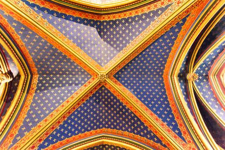 Colorful ornate blue ceiling with stars in a gothic chapel in Paris, France, Europe