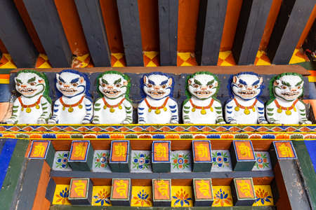 Ornate facade of Drametse Goemba monastery with deities in Bhutan, Asiaの写真素材