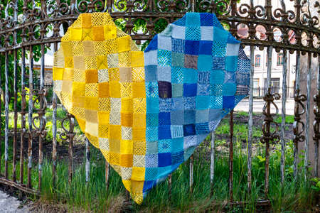 Love Ukraine heart made of fabric on a fence in Vilnius, Lithuania, Europeの写真素材