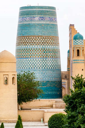 Kalta Minor minaret and city walls in Khiva, Uzbekistan, Central Asiaのeditorial素材