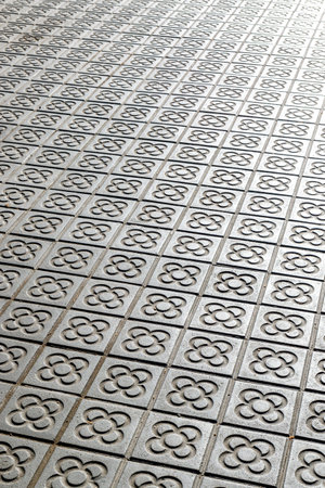 Sidewalk with panot (tiles with flower inside) in Barcelona, Catalonia, Spain, Europe