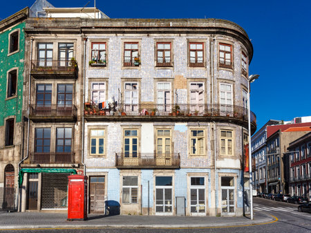 Facades of old buildings and a red telephone booth in the center of Porto, Portugal, Europeの写真素材