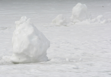 Snow Mounds On A Frozen Pond