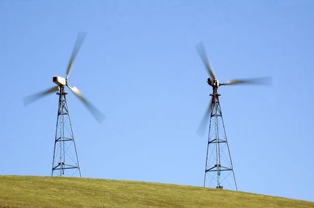 wind generators in california taken at a slower shutter speed so as to illustrate the speed of the...