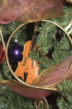 variety of Christmas tree ornaments on an artificial tree also adorned with lightsの写真素材