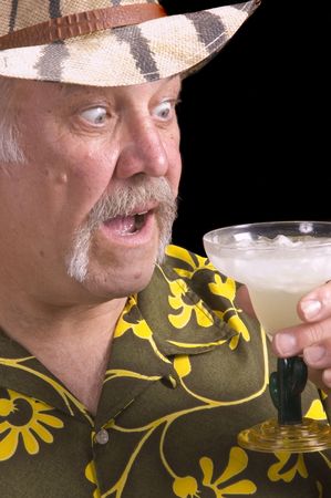 Man in floral shirt Hawaiian shirt, with a fu manchu mustache, safari hat and Margarita doing a Jimmy Buffet impersonationの写真素材