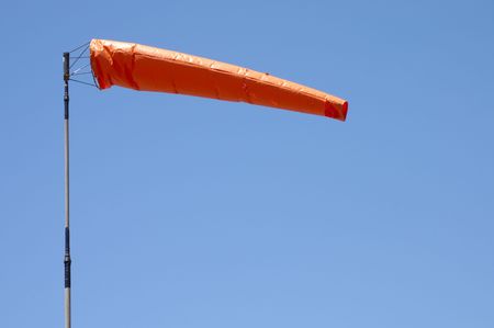 Orange windsock giving the direction and strength of the windの写真素材