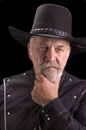 Handsome olld -boomer Cowboy dressed in black and looking like Buffalo Bill Cody