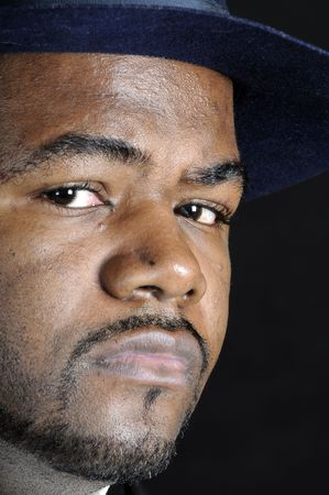 young bearded African American man in a hat and suit