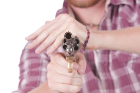 looking down the muzzle of a revolver from close range with shallow DOF