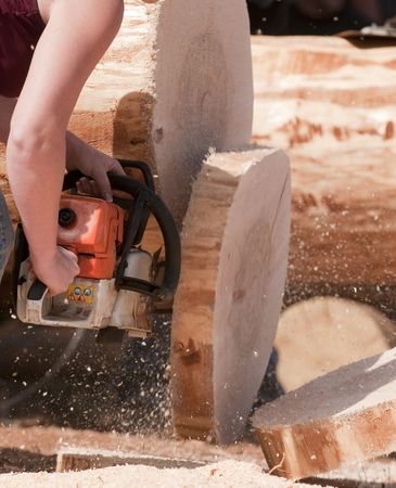 chainsaw cutting through log in lumberjack competitionの写真素材
