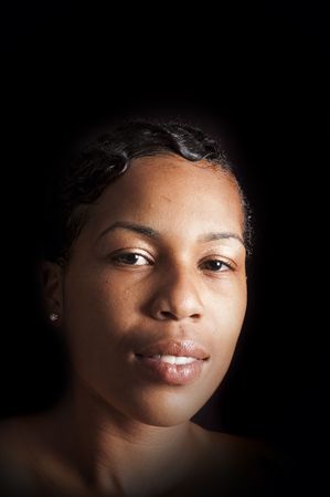 beautiful African American woman over a black backgroundの写真素材