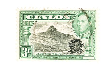 CEYLON - Circa 1946 : A vintage Ceylon postage stamp image of a Adams peak and King George the sixth, value of 3 cents, series circa 1946の写真素材