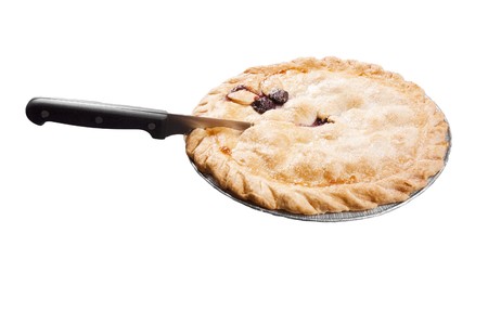Cherry pie in a dish with a knife preparing to cut a slice out of it, isolated on whiteの写真素材