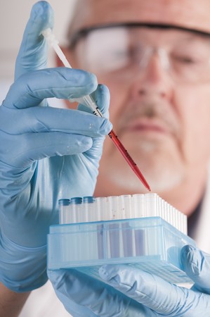 Research scientist with blood samples and culture dish for analysisの写真素材