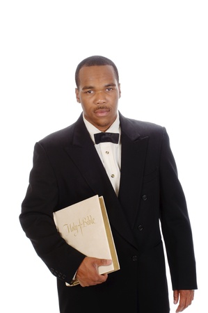 African American preacher holding a bible, isolated over whiteの写真素材