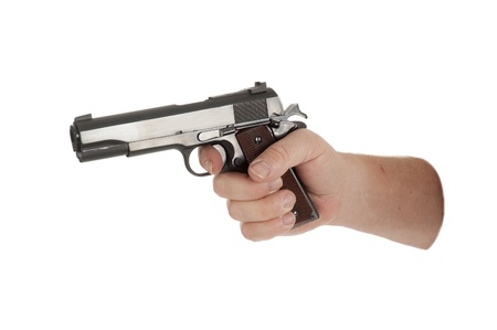 handgun cocked in a hand isolated on white