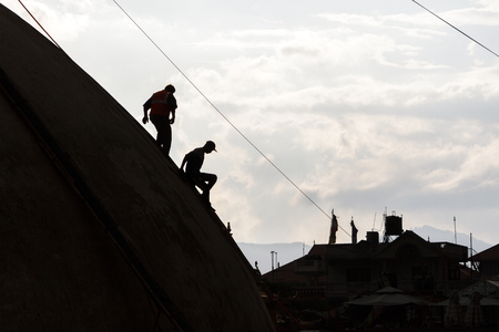 KATHMANDU, NEPAL - 9/23/2015: Laborers descend the Boudhanath Stupa during post earthquake repairs in Kathmandu, Nepal.のeditorial素材