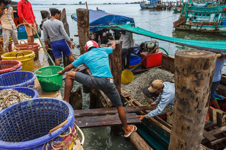SIHANOUKVILLE, CAMBODIA - 7/20/2015: Fishermen prepare for the day in a fishing village.のeditorial素材