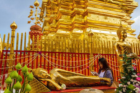 CHIANG MAI, THAILAND - 12/8/2014: A Buddhist woman makes a lotus flower offering at Wat Phra That Doi Suthep temple.のeditorial素材