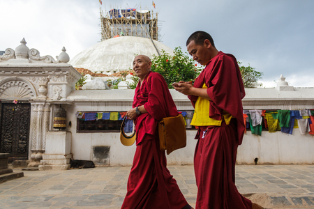 KATHMANDU, NEPAL - 9/23/2015: Tibetan monks walk around the Boudhanath Stupa in Kathmandu, Nepal.のeditorial素材