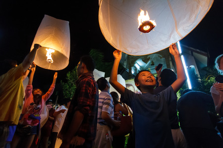 CHIANG MAI, THAILAND - 12/30/2015: A boy releases a floating lantern at a temple on New Year's Eve in Chiang Mai, Thailand.のeditorial素材