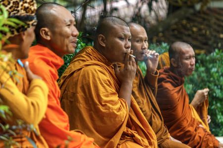 CHIANG MAI, THAILAND - 12/8/2014: A group of monks take a break to smoke at Wat Phra That Doi Suthep.のeditorial素材