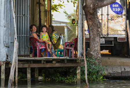 CAN THO, VIETNAM - 3/24/2016: A woman and child at their home on the Mekong river near Cai Rang floating market in Can Tho, Vietnam.のeditorial素材