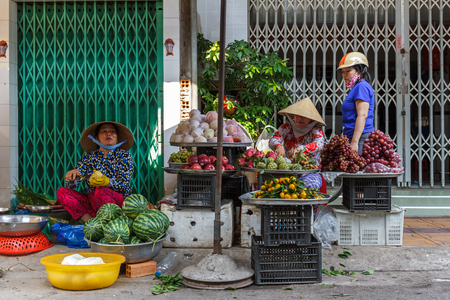NGA BAY, VIETNAM - 3/26/2016: Fruit vendors at a Mekong Delta market in Nga Bay, Vietnamのeditorial素材