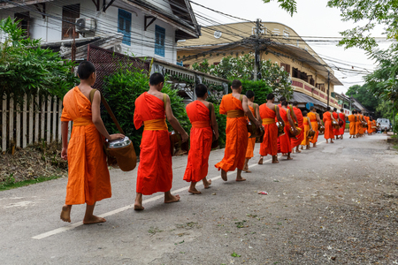 Buddhist monks in a line in Luang Prabang, Laosの写真素材