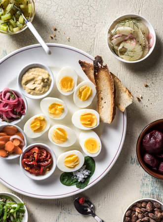 Tapas with tomatoes, onions, bacon, hardboiled eggs, carrots, toasted bread, celery, saltの写真素材